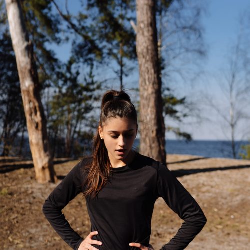 Young woman walks in the park and posing for the camera