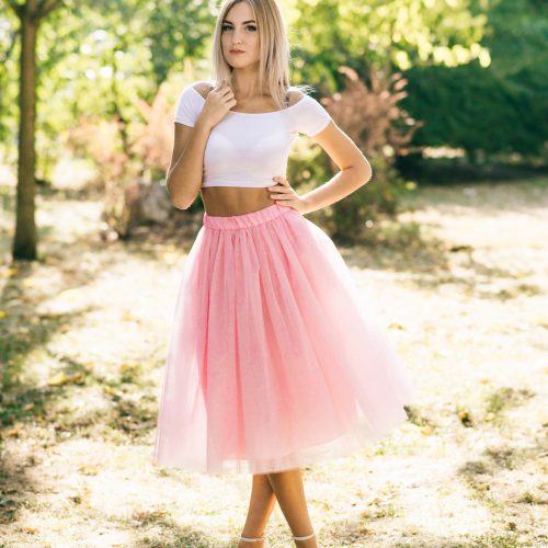 beautiful girl in colored skirt standing in the park
