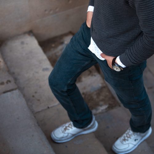 Man in casual outfits going up the stairs. High quality photo