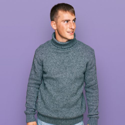 Young blond man wearing casual clothes looking away to side with smile on face, natural expression. laughing confident.