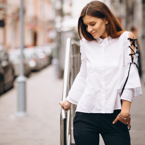 Young business woman standing outside office center